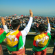 Protesters wearing traditional Shan dress make the three-figner salute as others hold signs during a demonstration against the Myanmar military coup in Inle Lake, Shan state on February 11, 2021.